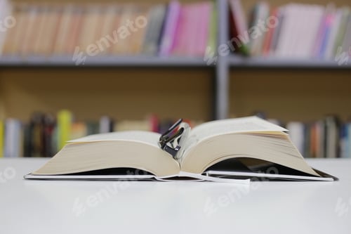 Preview: An Open Book On A Desk In The Library