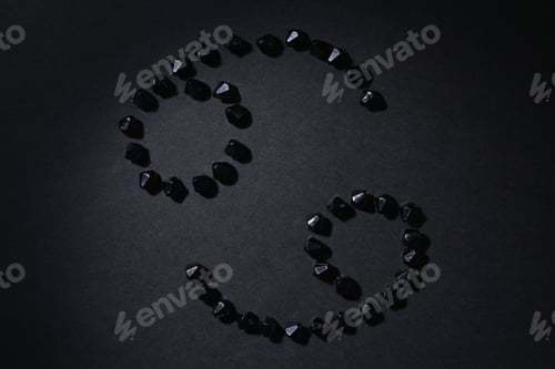 Preview: Symbol Of The Zodiac Sign Cancer Made By Black Stones On A Black Background. Low Dark Key