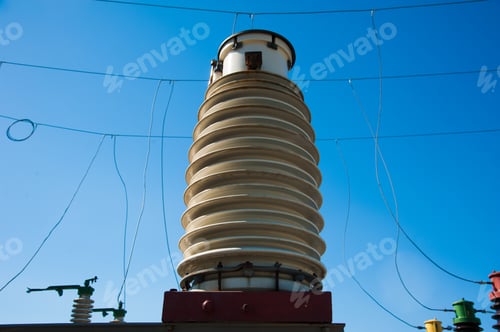 High Voltage Power Transformer Substation On Blue Sky Background
