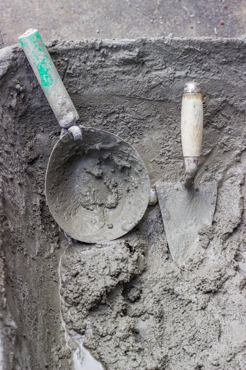Preview: Mason Mortar Tools In Cement Mixing Trough At Construction Site.