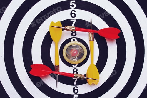 Preview: Unpacked Condom On The Background Of A Dartboard Target Darts, Toned