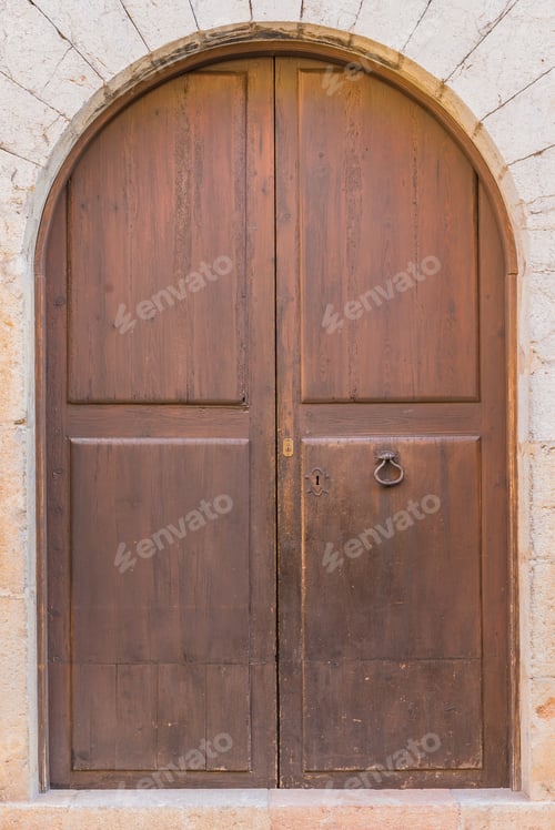 Preview: Antique Wooden Door With Stone Doorway Arch.