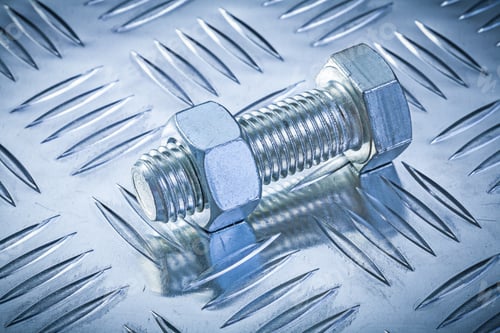 Preview: Stainless Bolt And Nut On Grooved Metal Background Construction Concept.