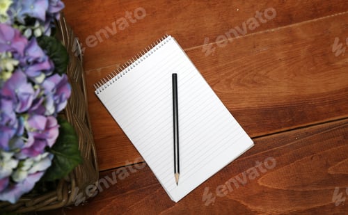 Preview: Pencil And Notebook On A Wooden Table Near The Blue Hydrangeas.