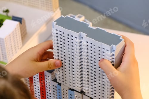 Preview: A Child Builds A Toy Multi-Storey House - Simulator Of The City And Urbanization