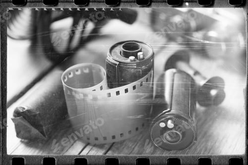 Vista previa: Stylized Photo Of Rolled Up Film, Cassette And Retro Camera. Vintage Effect.