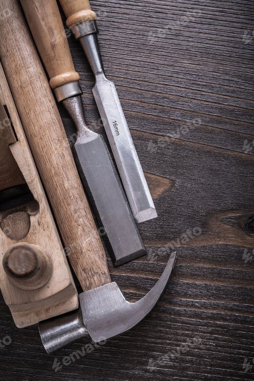 Preview: Vertical View Of Claw Hammer Wooden Planer And Flat Chisels On Vintage Wood Board Construction