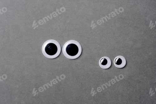 Preview: Two Pairs Of Looking Googly Eyes On Grey Background.