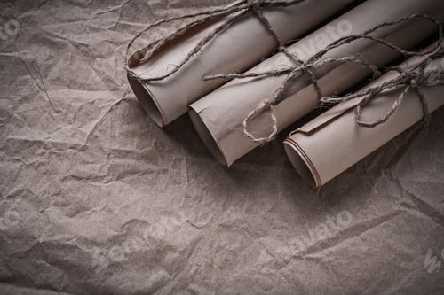 Preview: Stack Of Vintage Paper Rolls On Crumpled Wrapping Sheet.