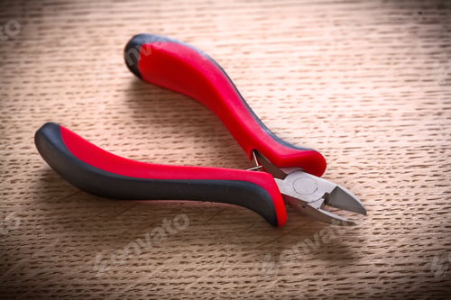 Preview: Small Nippers With Black Red Handles On Wooden Board