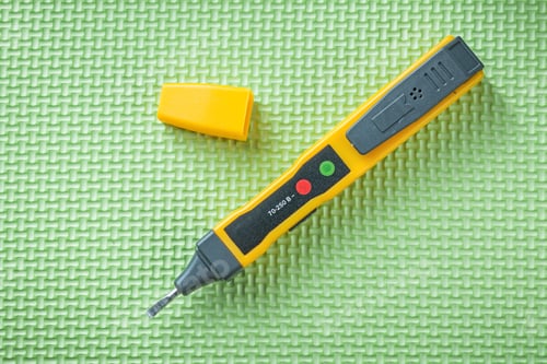 Preview: Electrical Tester Indicating Device On Green Background Electricity Concept.