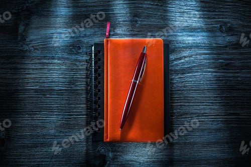 Preview: Notebooks Pen On Vintage Wooden Board Top View.