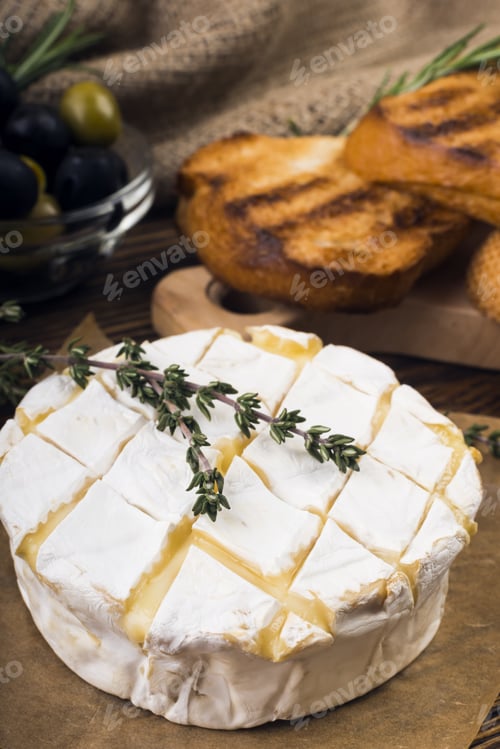Preview: Camembert Cheese With Thyme And Toasted Bread On A Wooden Board