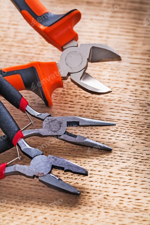 Preview: Nippers And Pliers On Wooden Board Construction Concept