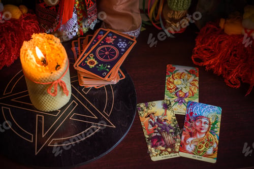 Preview: Cartomancy. A Fortune Teller, Tarot Cards. On The Table Are Candles And Fortune-Telling Objects