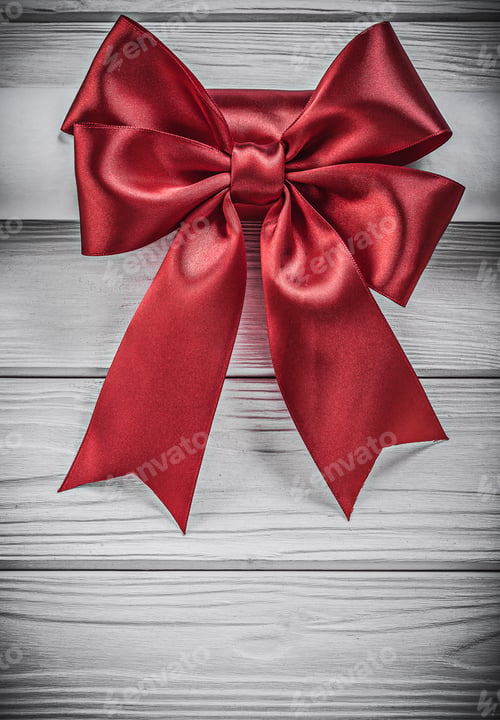 Preview: Paper Roll With Red Bow On Wooden Board Holidays Concept.