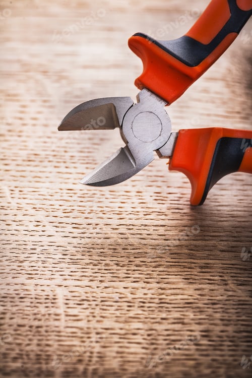 Preview: Opened Nippers Close Up On Wooden Board Construction Concept