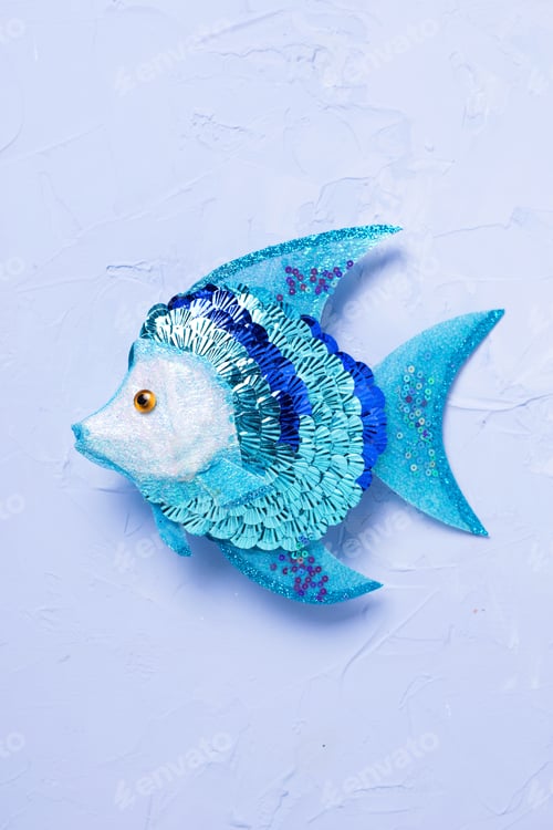 Preview: Decorative Fish On Blue Textured Background. Selective Focus.