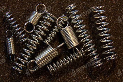 Preview: Flexible Steel Spring On A Dark Background