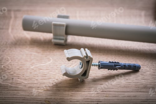 Preview: Polypropylene Fixator And Pipe With Clips On Wooden Board