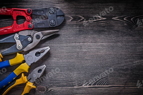 Preview: Stainless Wire Steel Cutter Pliers On Wooden Board Copy Space.