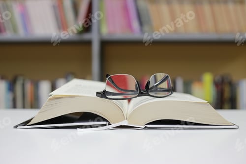 Preview: An Open Book On A Desk In The Library