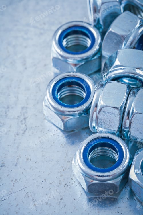 Preview: Collection Of Steel Screw Nuts On Flat Metallic Background Construction Concept.