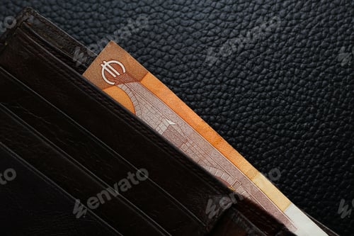 Preview: Euro In A Brown Wallet Close-Up On A Black Leather Background