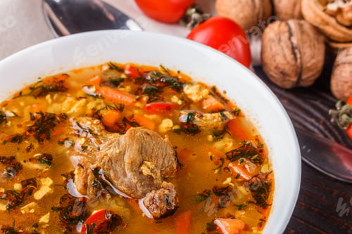Preview: Georgian Soup. Kharcho With Rice, Tomato, Beef, Garlic And Herbs In Bowl On Wooden Table