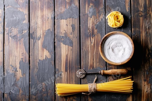 Preview: Raw Ingredients For Cooking: Italian Spaghetti Pasta And Flour Over Dark Wooden Background. Top
