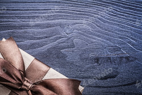 Preview: Present Box With Satin Bow On Wooden Board.