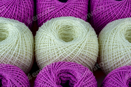 Preview: Three White Ball Of Yarn Among Purple Balls