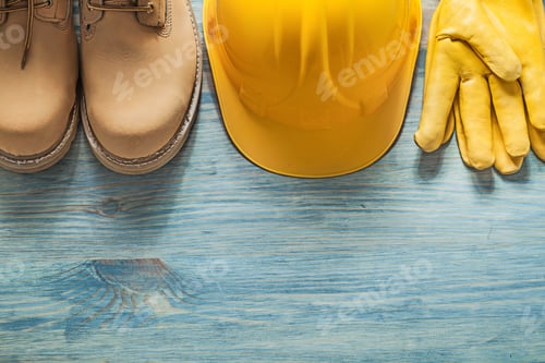 Preview: Pair Of Waterproof Boots Hard Hat Leather Protective Gloves On Wooden Board Construction Concept.