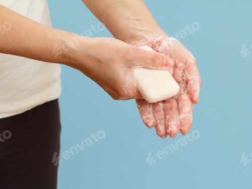 Preview: Woman Washing Hands With Soap On A Blue Background. Correctly Cleaning Hands Protects Against