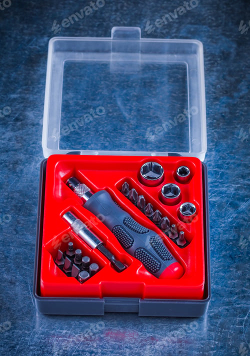 Preview: Opened Toolbox With Screwdriver And Replaceable Bits On Scratched Metallic Background Construction