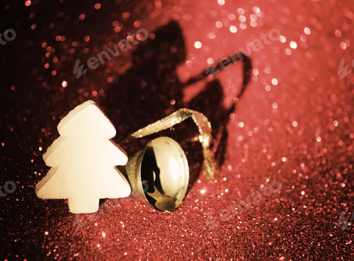 Preview: Decorative Wooden Christmas Tree And Bell On Glitter Bokeh Abstract Background.