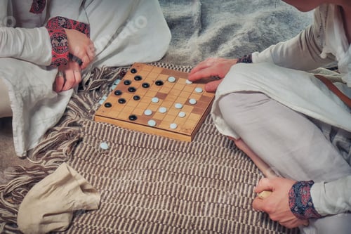 Preview: Players At The Board Game In Vintage Style - Tafl, Hnefatafl. Two People Play Tavlei, Closeup.