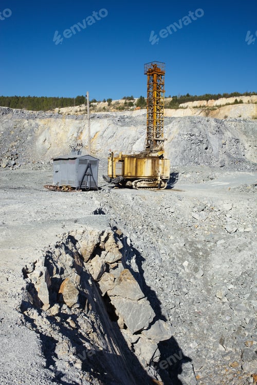 Preview: Destroyed Rocks Against The Background Of A Mining Drilling Machine In A Limestone Quarry. Mining