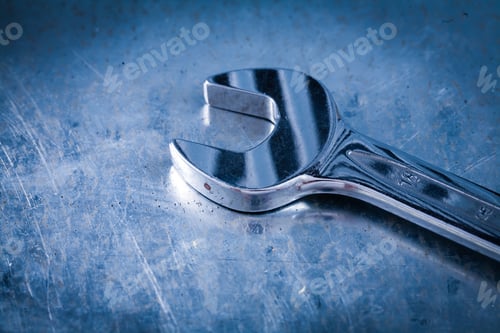 Preview: Stainless Hook Wrench On Scratched Metallic Background Close Up View Construction Concept.