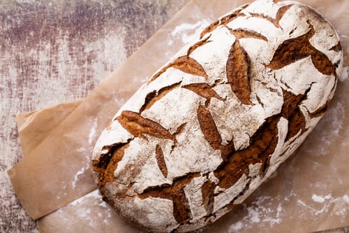 Preview: Freshly Baked Bread On Dark Gray Kitchen Table, Top View.