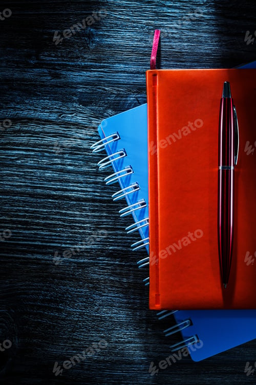 Preview: Composition Of Pocketbooks Pen On Wooden Board.