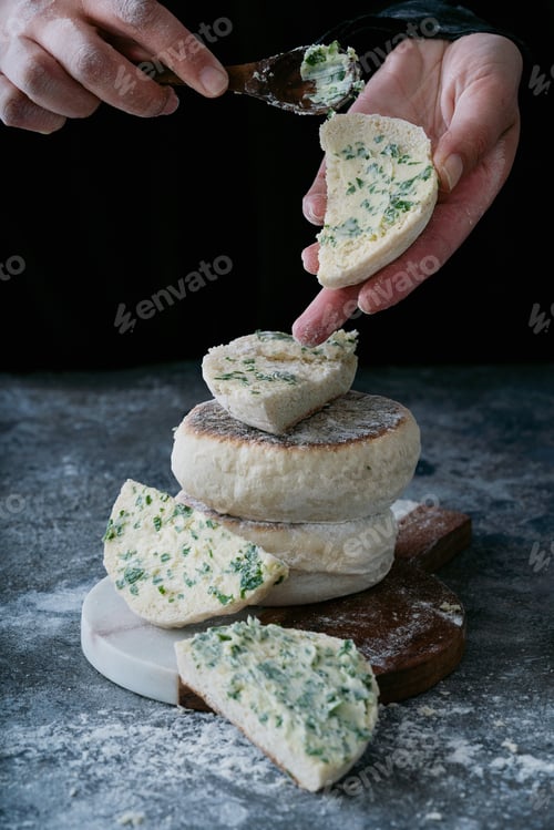 Preview: Traditional Portuguese Flat Circular Bread Bolo Do Caco. Female Hands Buttering The Bread. Madeira