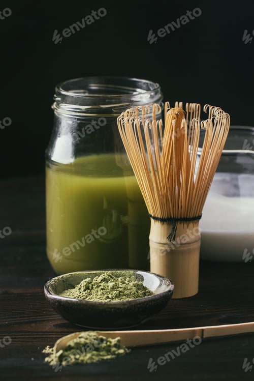 Preview: Green Matcha Tea Served With Cream And Green Matcha Powder With Various Bamboo Accessories For Tea