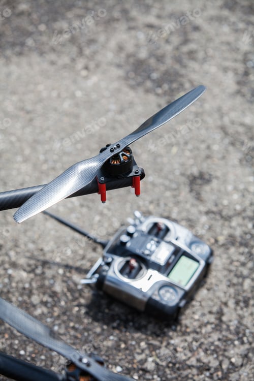 Preview: Close Up Shot Of One Of The Propellers Form An Octocopter Drone, With A Remote Controller.