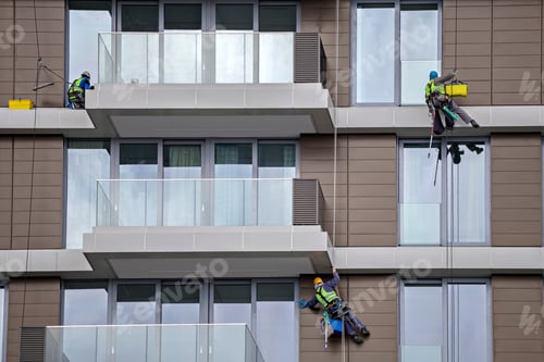 Preview: Worker Using Rope To Clean A High Apartment Building, Steeplejack Works. Mountain Climber Washes
