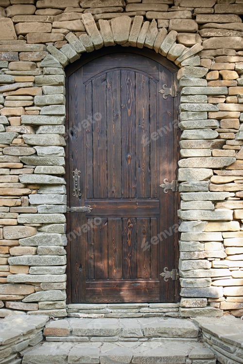 Preview: Antique Wooden Door With Cast-Iron Hinges On A Stone Wall Background.