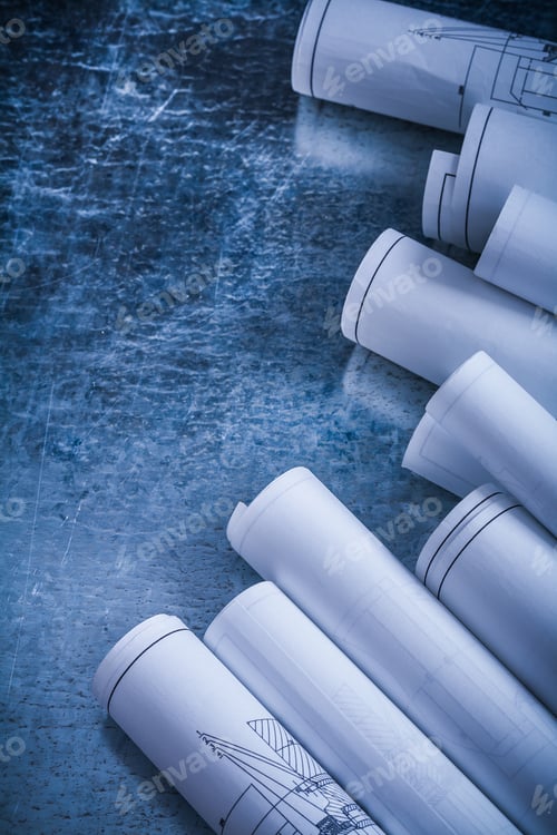 Preview: Metallic Scratched Background With Rolls Of White Blueprints Construction Concept.