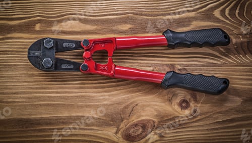 Preview: Bolt Cutter On Vintage Wooden Board Construction Concept.