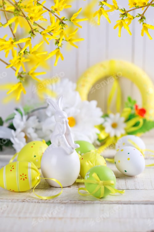 Preview: Colorful Easter Eggs And Rabbit On White Wooden Background. Easter Background. Selective Focus Is