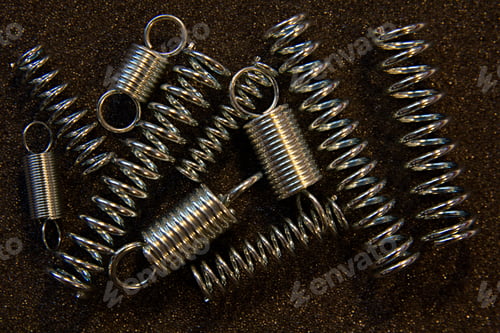 Preview: Flexible Steel Spring On A Dark Background